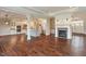 Spacious open living area with hardwood floors, a fireplace, and a modern kitchen at 16548 Grand Cypress Dr, Noblesville, IN 46060