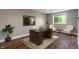 Well-lit office with hardwood floors, desk, and chairs near a window and nautical-themed art at 16548 Grand Cypress Dr, Noblesville, IN 46060