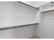 Clean and spacious walk-in closet with built-in shelving and wooden closet rods at 16548 Grand Cypress Dr, Noblesville, IN 46060