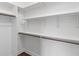Bright walk-in closet featuring built-in shelving, wooden closet rods, and hardwood floors at 16548 Grand Cypress Dr, Noblesville, IN 46060