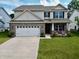 Beautiful two-story home with a brick and siding exterior, a two car garage, and well-manicured lawn at 16551 Branham Dr, Fishers, IN 46040