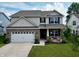 Charming two-story home with a brick and siding exterior, well-manicured lawn, and an attached two-car garage at 16551 Branham Dr, Fishers, IN 46040
