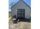 The rear exterior has secure doors with decorative wrought iron and a seating area at 2021 Columbia Ave, Indianapolis, IN 46202