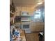 The kitchen has white appliances and cabinets, with wood-look flooring at 2021 Columbia Ave, Indianapolis, IN 46202