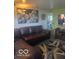 Living room featuring a brown leather sofa with cloud art on the wall at 2021 Columbia Ave, Indianapolis, IN 46202