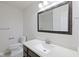 This bathroom features a modern single sink vanity, a large mirror, and a toilet at 2078 Seneca Ln, Plainfield, IN 46168