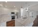 Modern kitchen featuring white cabinets, stainless steel appliances, and a marble-top island at 2078 Seneca Ln, Plainfield, IN 46168