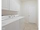 Bright laundry room with white cabinetry and modern appliances at 2078 Seneca Ln, Plainfield, IN 46168