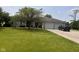 Inviting single-story brick home with a lush green lawn, mature tree, and convenient driveway at 2213 Holden Dr, Anderson, IN 46012