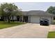 Charming brick ranch home with a well-maintained front yard and attached two-car garage at 2213 Holden Dr, Anderson, IN 46012
