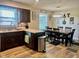 Well-equipped eat-in kitchen with dark wood cabinetry, stainless steel appliances, and dining area at 2213 Holden Dr, Anderson, IN 46012