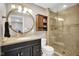Well-lit bathroom features a vanity with storage and a tiled walk-in shower with glass door at 2384 Fairfax Dr, Columbus, IN 47203