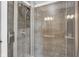 Modern bathroom with glass enclosed shower featuring gray tile and chrome shower head and faucet at 2384 Fairfax Dr, Columbus, IN 47203