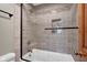 Updated bathroom with shower over tub, decorative tile accent, glass door, and brushed metal fixtures at 2384 Fairfax Dr, Columbus, IN 47203