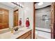Bathroom showcasing a vanity, mirror, and tiled shower over tub with decorative mosaic at 2384 Fairfax Dr, Columbus, IN 47203