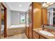 Bathroom with a soaking tub, double vanity, and abundant natural light from the window at 2384 Fairfax Dr, Columbus, IN 47203