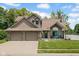 Charming two-story home features a manicured lawn, a two-car garage, and beautiful curb appeal at 2384 Fairfax Dr, Columbus, IN 47203