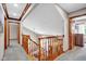 Hallway with wooden banister overlooking the dining room at 2384 Fairfax Dr, Columbus, IN 47203