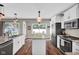 Bright kitchen with stainless steel appliances, an island, and a view of the outdoor pool at 2384 Fairfax Dr, Columbus, IN 47203