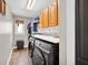 Practical laundry room with modern washer and dryer, storage cabinets, and convenient shelving at 2384 Fairfax Dr, Columbus, IN 47203