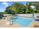 Backyard pool area with an in-ground pool, surrounded by concrete and enclosed with a white fence at 2384 Fairfax Dr, Columbus, IN 47203