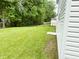 Spacious backyard with green grass, mature trees, and a chainlink fence at 3314 Montgomery Dr, Indianapolis, IN 46227