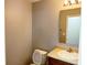 Small bathroom featuring a toilet, sink, and mirror with vanity lighting at 3314 Montgomery Dr, Indianapolis, IN 46227