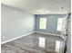 A cozy bedroom featuring stylish gray walls, modern trim, and lovely wood-look floors at 3314 Montgomery Dr, Indianapolis, IN 46227