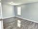 A cozy bedroom featuring stylish gray walls, modern trim, and lovely wood-look floors at 3314 Montgomery Dr, Indianapolis, IN 46227