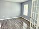 A cozy bedroom featuring stylish gray walls, modern trim, and lovely wood-look floors at 3314 Montgomery Dr, Indianapolis, IN 46227