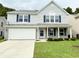 Charming two-story home with light blue siding, brick accents, and a well-manicured lawn at 3314 Montgomery Dr, Indianapolis, IN 46227