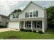 Charming two-story home with light blue siding, brick accents, and a well-manicured lawn at 3314 Montgomery Dr, Indianapolis, IN 46227