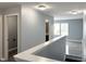 Upstairs hallway featuring neutral paint color, vinyl flooring, and a bathroom visible at 3314 Montgomery Dr, Indianapolis, IN 46227