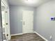 Hallway with new flooring, white door, and view of another room through an open door at 3314 Montgomery Dr, Indianapolis, IN 46227