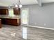 Kitchen with stainless steel dishwasher, wood cabinets and grey wood-like flooring at 3314 Montgomery Dr, Indianapolis, IN 46227