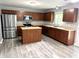 Well-equipped kitchen with stainless steel appliances, center island, and wood cabinets at 3314 Montgomery Dr, Indianapolis, IN 46227