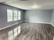 Spacious living room featuring wood flooring and large windows providing natural light at 3314 Montgomery Dr, Indianapolis, IN 46227