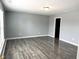 Spacious living room featuring wood flooring and a view into the kitchen at 3314 Montgomery Dr, Indianapolis, IN 46227