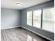 Bright living room featuring wood flooring and large windows with blinds at 3314 Montgomery Dr, Indianapolis, IN 46227