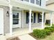 Covered porch with white columns and dark blue shutter accents. Address numbers visible at 3314 Montgomery Dr, Indianapolis, IN 46227
