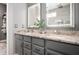 Modern bathroom with granite countertop, dual sinks, lighted mirrors, gray cabinets and a view of a glass enclosed shower at 3545 Inverness Blvd, Carmel, IN 46032