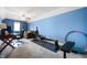 Spacious bonus room featuring bright blue walls, carpeting, desk area, sofa, and workout equipment at 3545 Inverness Blvd, Carmel, IN 46032