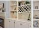 Elegant built-in shelving with a wine rack, display cabinets, and a fireplace at 3545 Inverness Blvd, Carmel, IN 46032