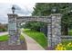Stone archway entrance to The Village community with manicured landscaping at 3545 Inverness Blvd, Carmel, IN 46032