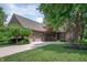 Beautiful brick home featuring a three-car garage, manicured lawn, and mature trees at 3545 Inverness Blvd, Carmel, IN 46032