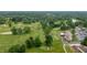 Overhead view of a golf course with mature trees and lush green grass at 3545 Inverness Blvd, Carmel, IN 46032