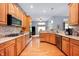 Spacious kitchen with wooden cabinets, granite countertops, and stainless steel appliances at 3545 Inverness Blvd, Carmel, IN 46032