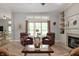 Bright living room with large windows, plush armchairs, and a traditional fireplace at 3545 Inverness Blvd, Carmel, IN 46032