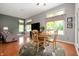 Inviting living room with ample natural light, wood floors, a cozy seating area, and a dining table with seating for four at 3545 Inverness Blvd, Carmel, IN 46032