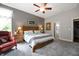 Comfortable main bedroom features carpet floors, a ceiling fan, neutral walls, and a large window for natural light at 3545 Inverness Blvd, Carmel, IN 46032